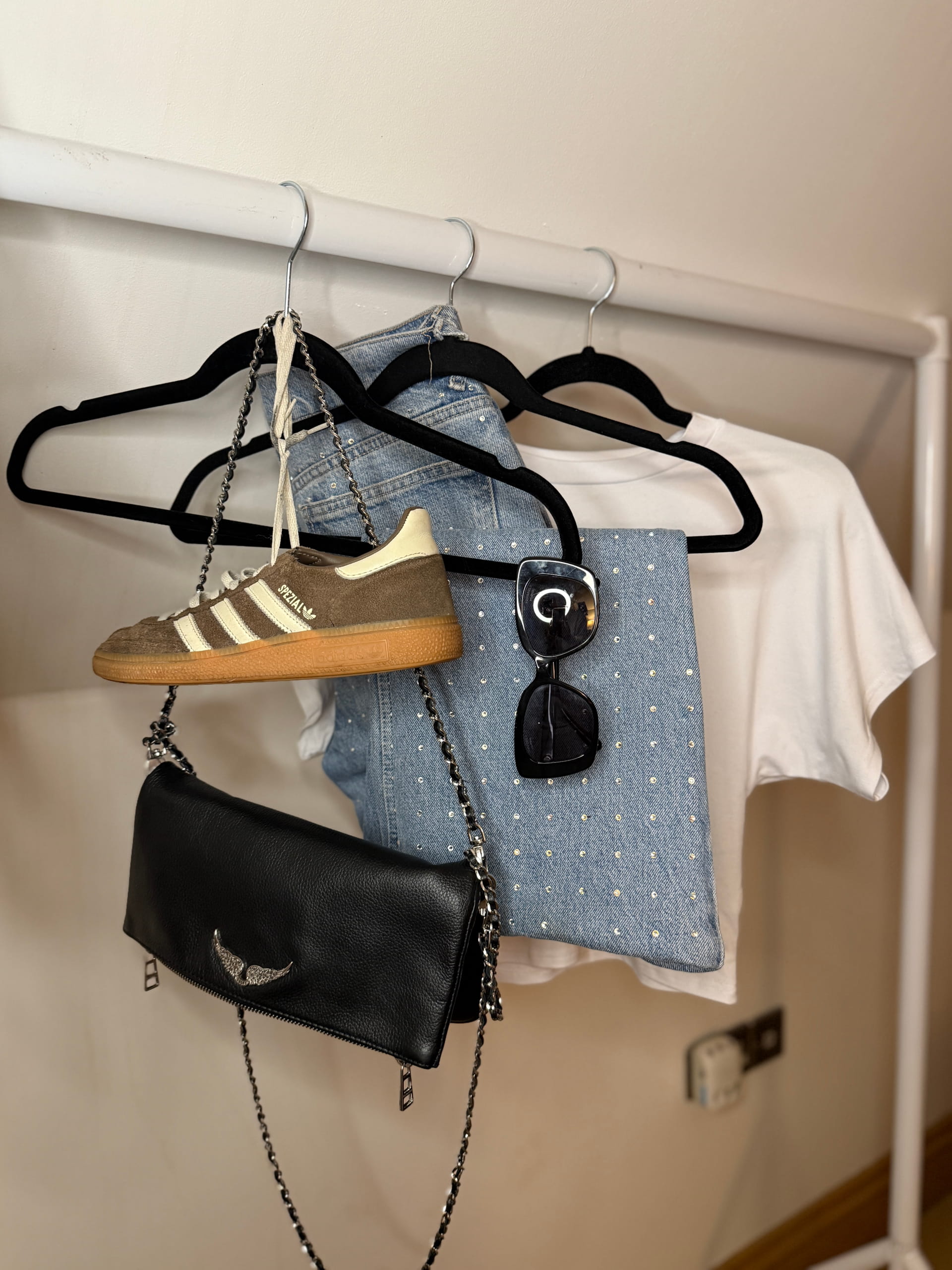 Clothes, Bag and Show hanging from a rail